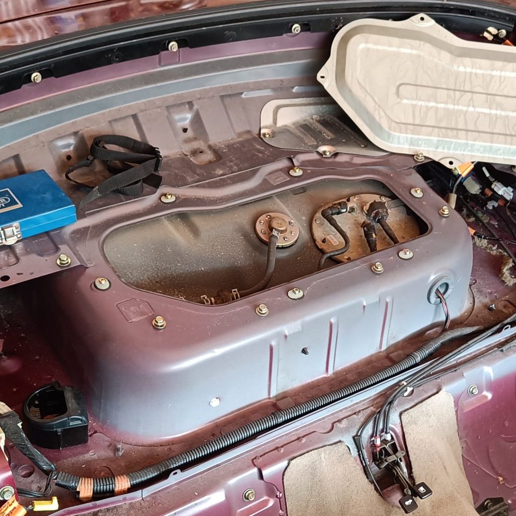 Image showing rear parcel shelf cover removed revealing top of fuel tank.