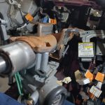 Image of wiring loom in and around the area under the dash on the driver's side.