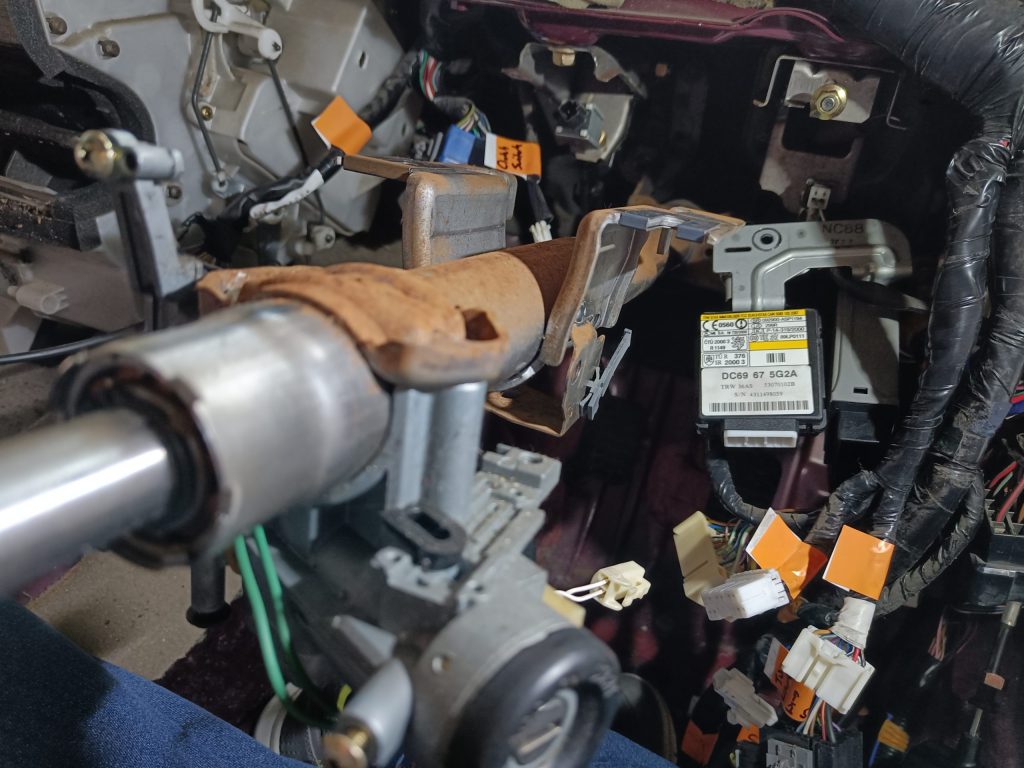 Image of wiring loom in and around the area under the dash on the driver's side.