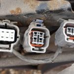 Image of connectors at front of engine near thermostat housing.