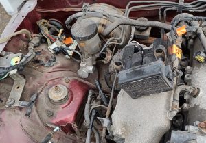 Image showing coolant header tank removed along with EVAP charcoal cannister, relays and fusebox.