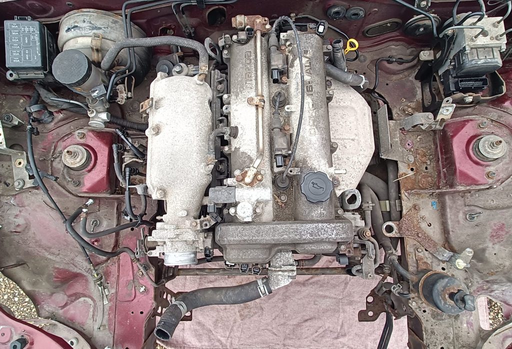 Image of engine bay without wiring harnesses.