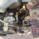 Image of power steering pump without pipework.