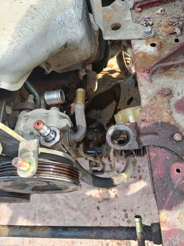 Image of power steering pump without pipework.