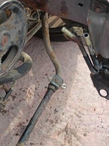Image of front anti-roll bar unbolted from body shell.