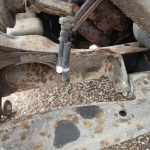 Image of clamped brake pipe to stop drips until pipe removed.