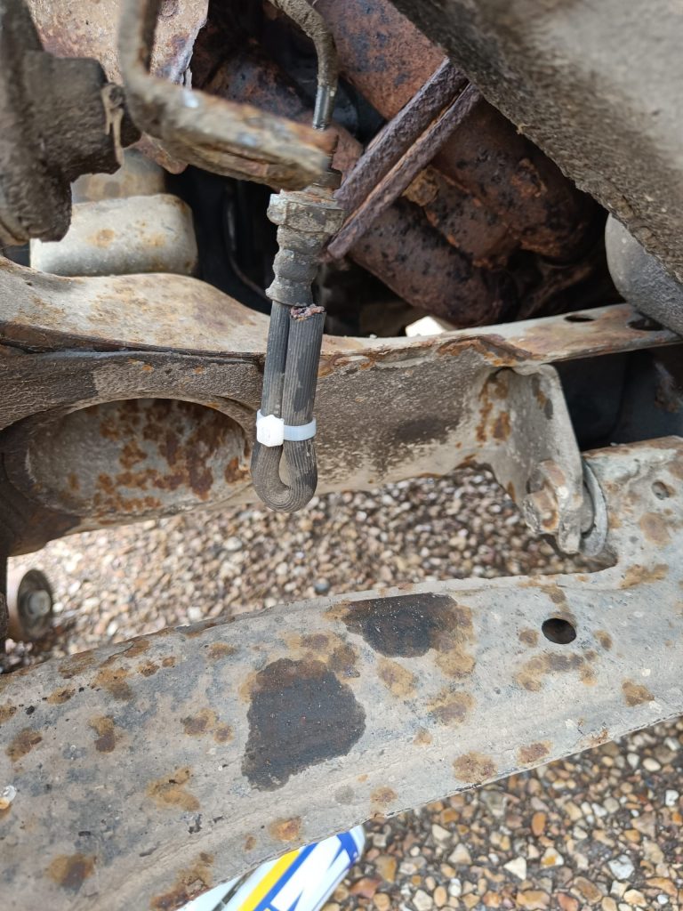 Image of clamped brake pipe to stop drips until pipe removed.
