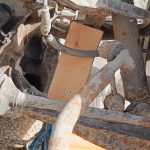 Image of wood block between front upper and lower wishbones.