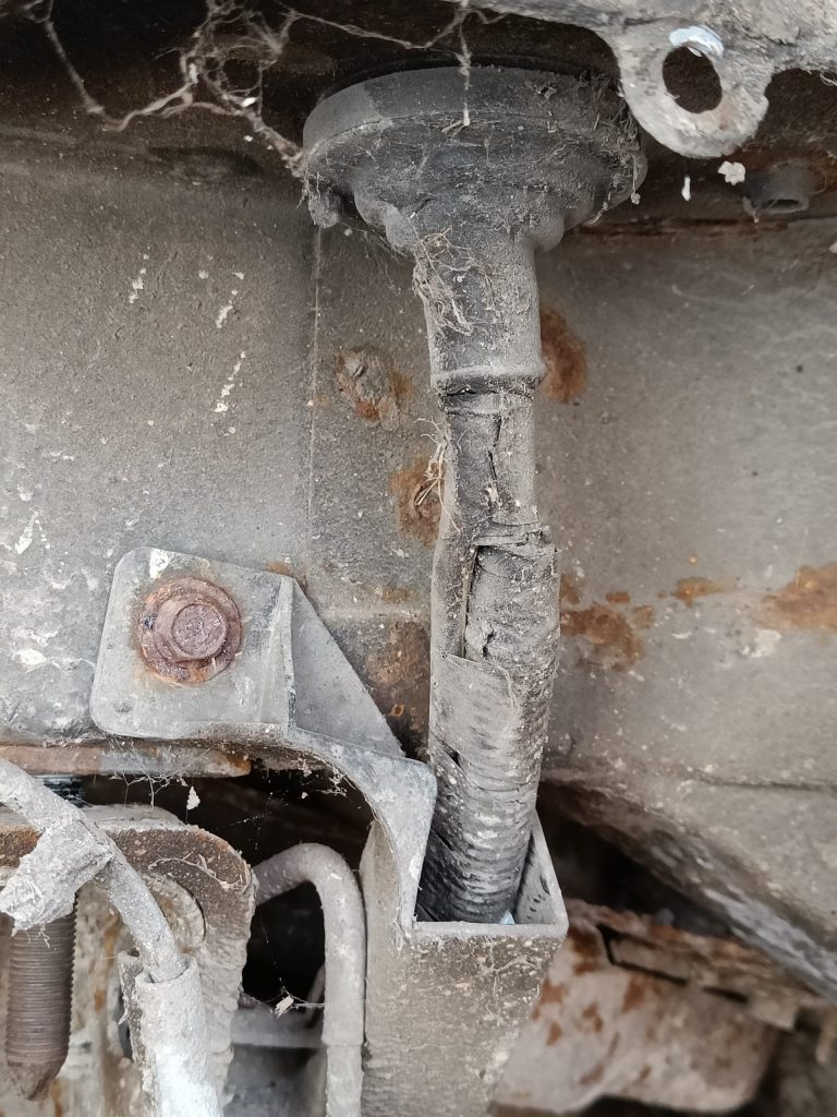 Image of o/s rear location where the battery cable passes through the body shell