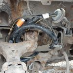 Image of the battery cable pushed through into wheel arch and tidied out of the way