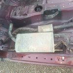 Image of rear sections of exhaust system in passenger footwell ready to scrap.