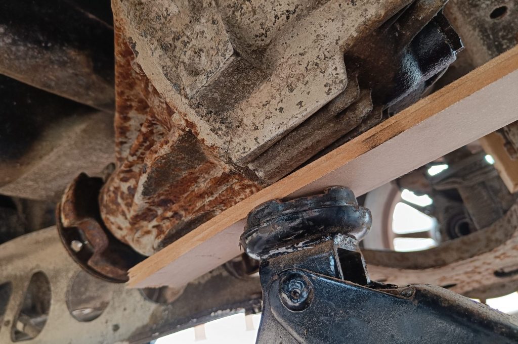 Image of diff supported by trolley jack ready for upper mounts to be released.