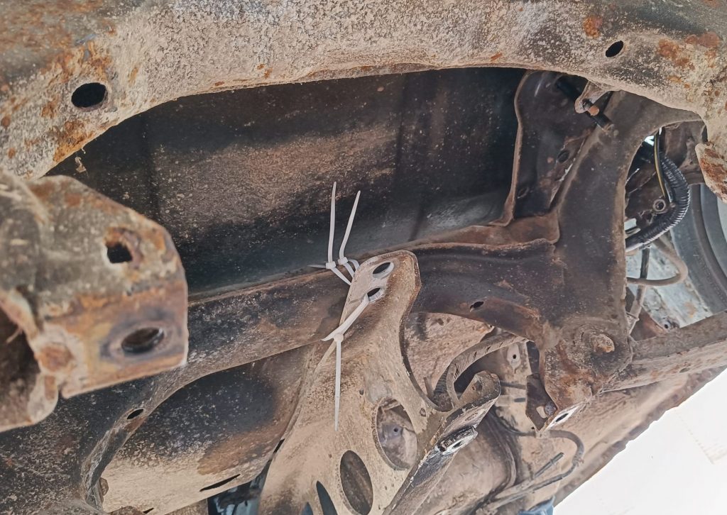 Image of PPF cable tied to rear subframe following diff removal.