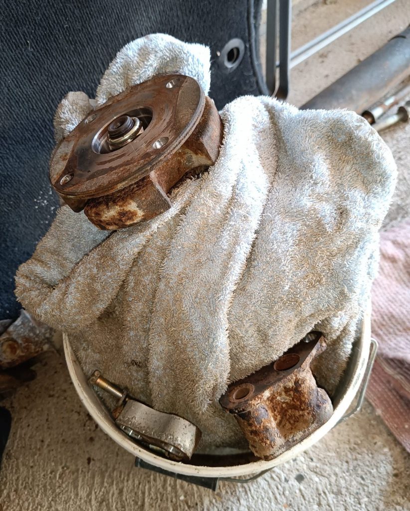 Image of diff 'nose' and fixings in a bucket awaiting refurbishment.