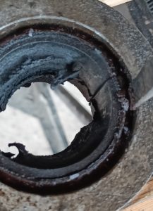 Image of screwdriver used start to peel back the edge of the diff bush prior to knocking out.