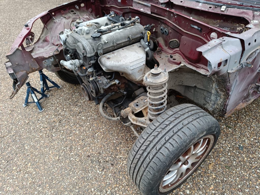 Image of donor MX5 with front panels and N/S inner wing / chassis rail removed.