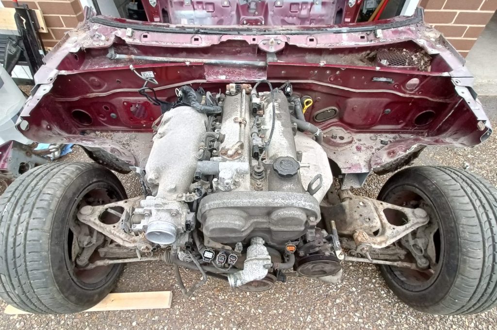 Image of donor MX5 with all front panels removed, along with front coil overs.