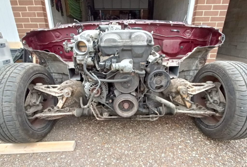 Image of donor MX5 with all front panels removed, along with front coil overs.