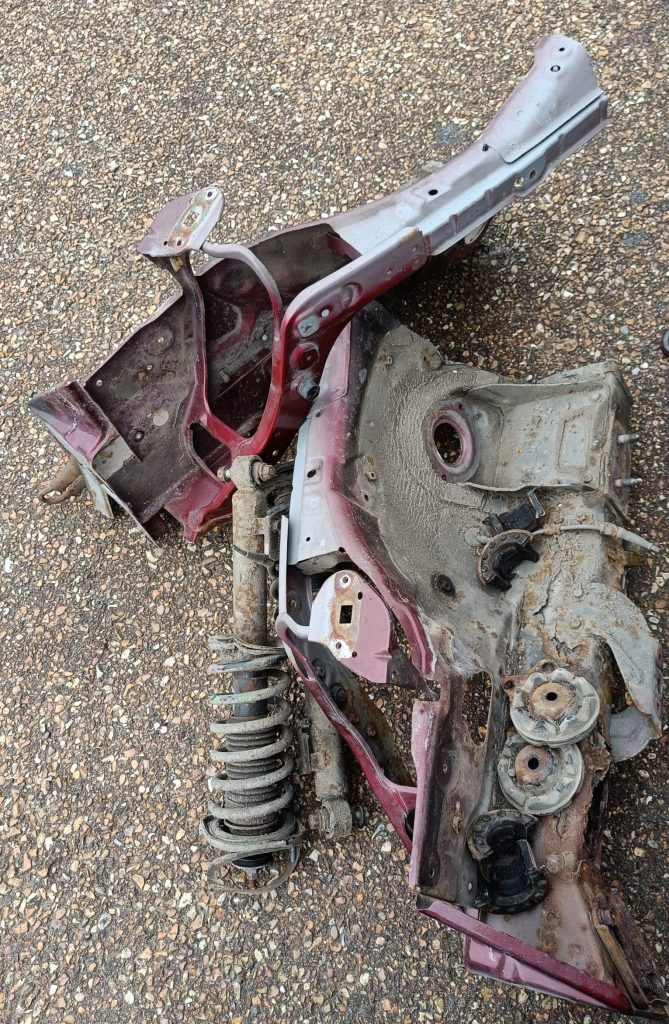 Image of the removed front inner wings and coil overs.