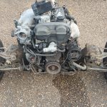 Image of engine, gearbox & front subframe after being rolled out from the body shell.
