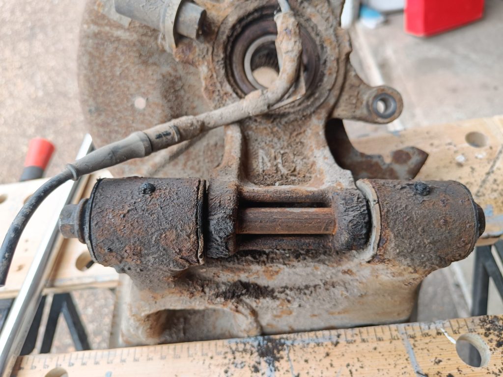 Image of lower rear wishbone in workmate to remove the long bolt and release the rear upright.