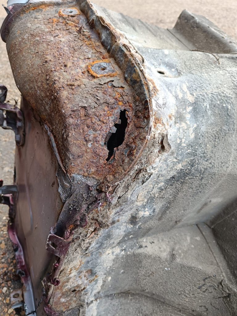 Image of rust hole in scrap passenger side sill.