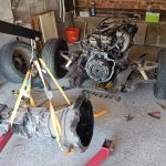 Image of gearbox lifted away from engine using engine hoist.