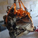 Image of engine hanging from engine hoist.