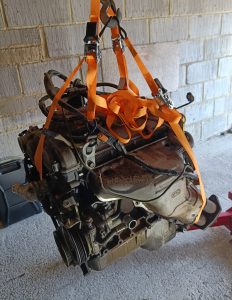 Image of engine hanging from engine hoist.