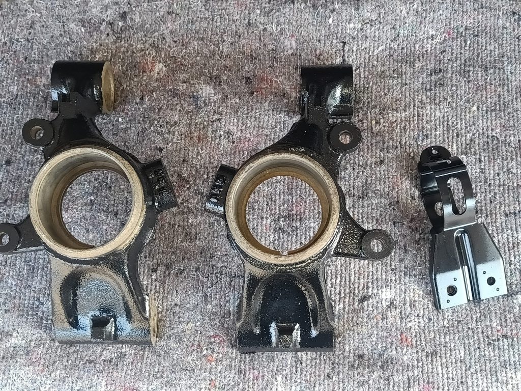 Image of rear uprights and fuel filter bracket after final paint.