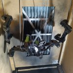 Image of inside of home brew spray booth with painted items drying.