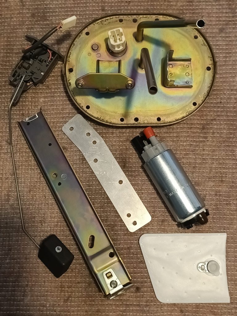 Image of dismantled fuel pump assembly ready for rebuild to fit MK tank, along with pump upgrade.