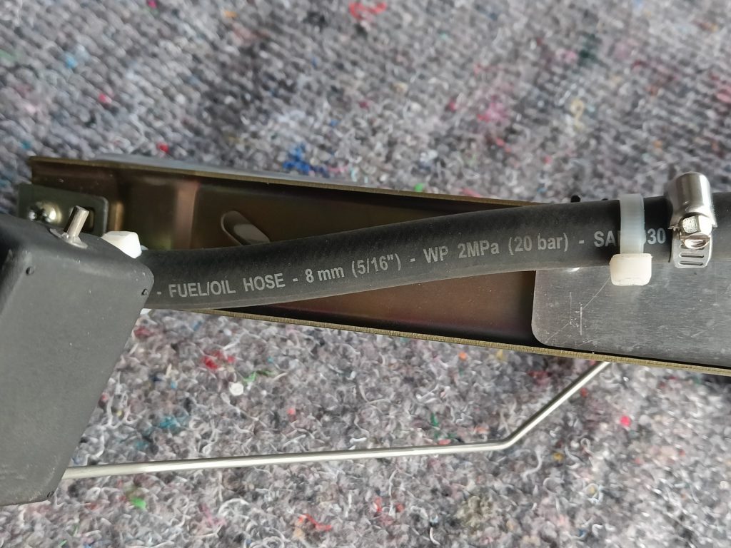 Image of extension to the fuel return pipe on the fuel pump assembly.