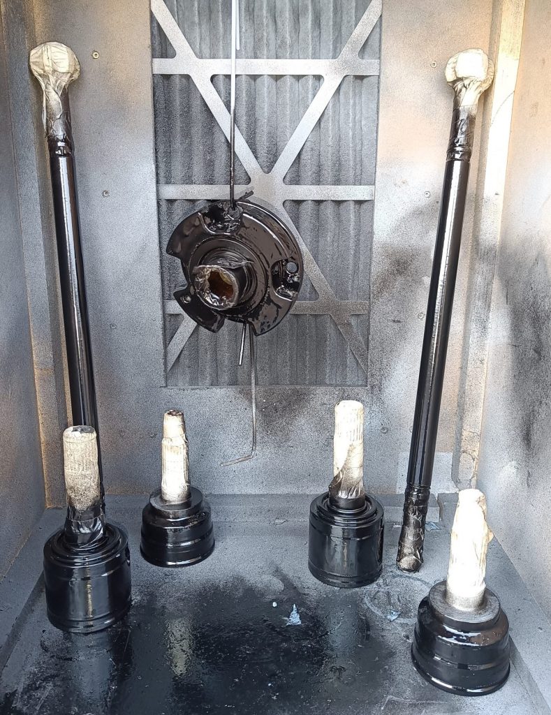 Image of stripped driveshafts and diff input flange after POR-15 paint system applied.