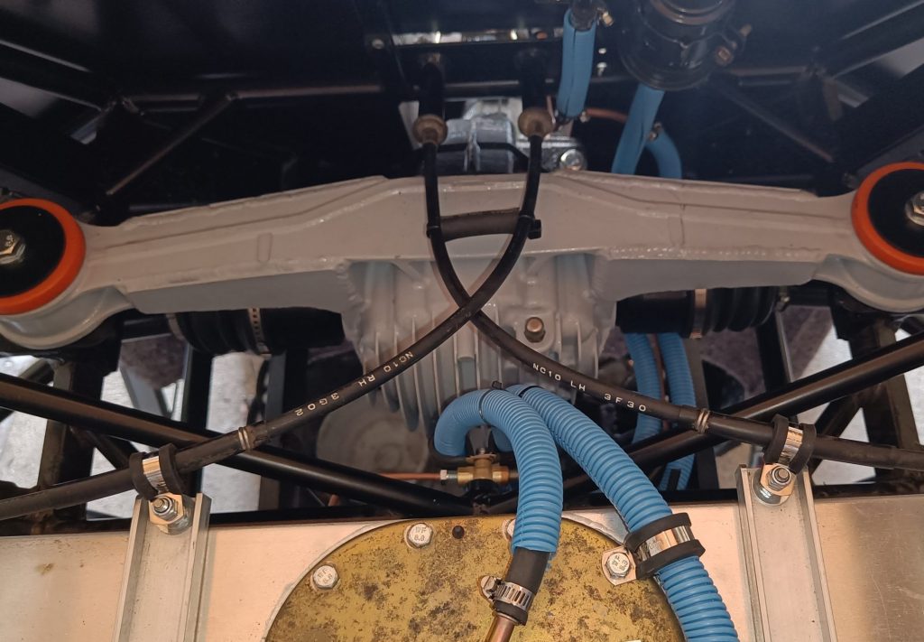 Image of new handbrake cable fixing points using the fuel tank fixing rods and P clips