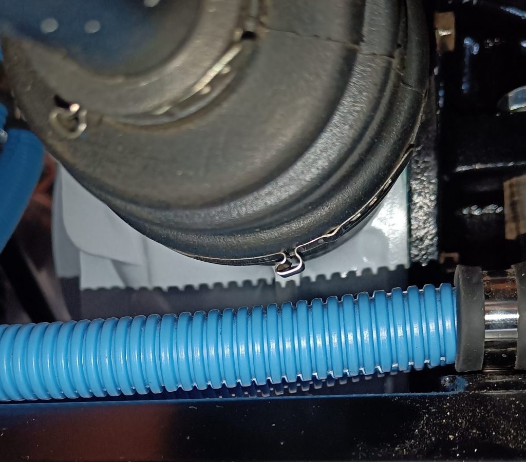 Image of clearance between OS inner CV joint boot and fuel pipe.