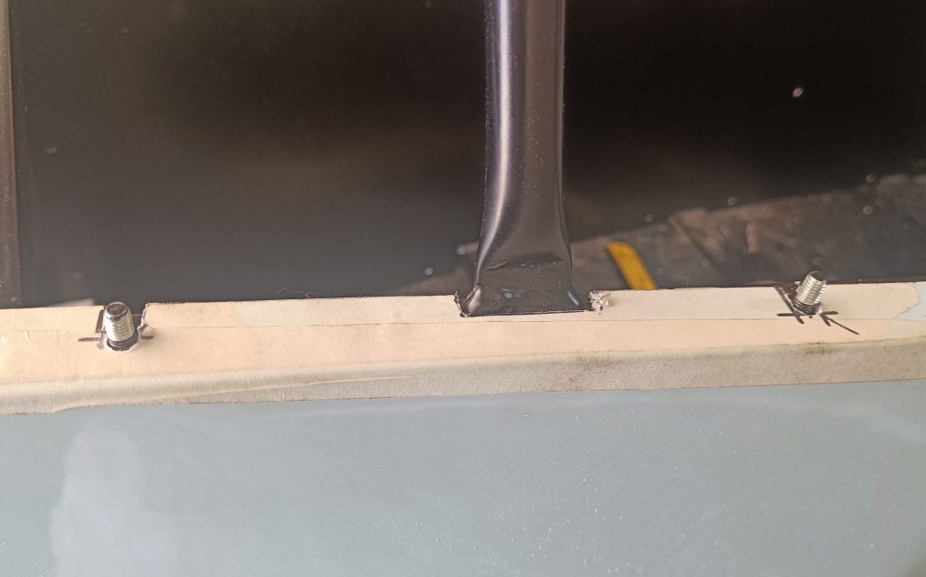 Image of NS side panel trimming around chassis studs and scuttle hoop