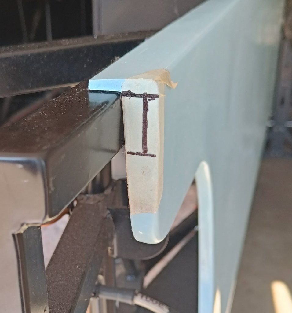 Image of front end of NS side panel marked for trimming