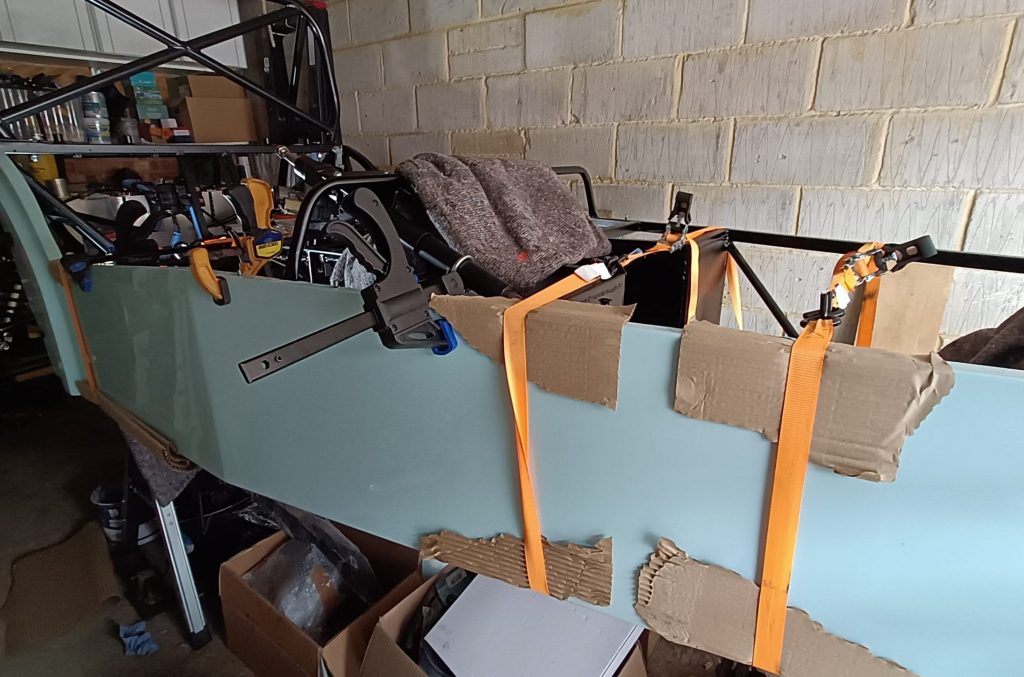 Image of OS side panel being bonded on.