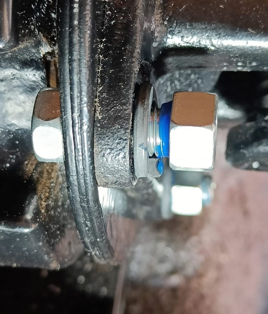 Image of propshaft to diff flange fixings being threadlocked and then torqued to 55Nm