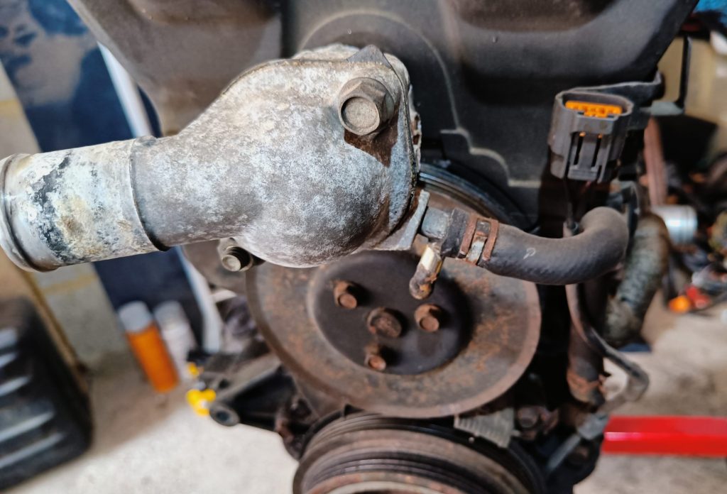 Image of front of engine showing thermostat cover.