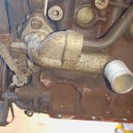Image of LHS front of engine showing water mixer manifold & crank position sensor location.
