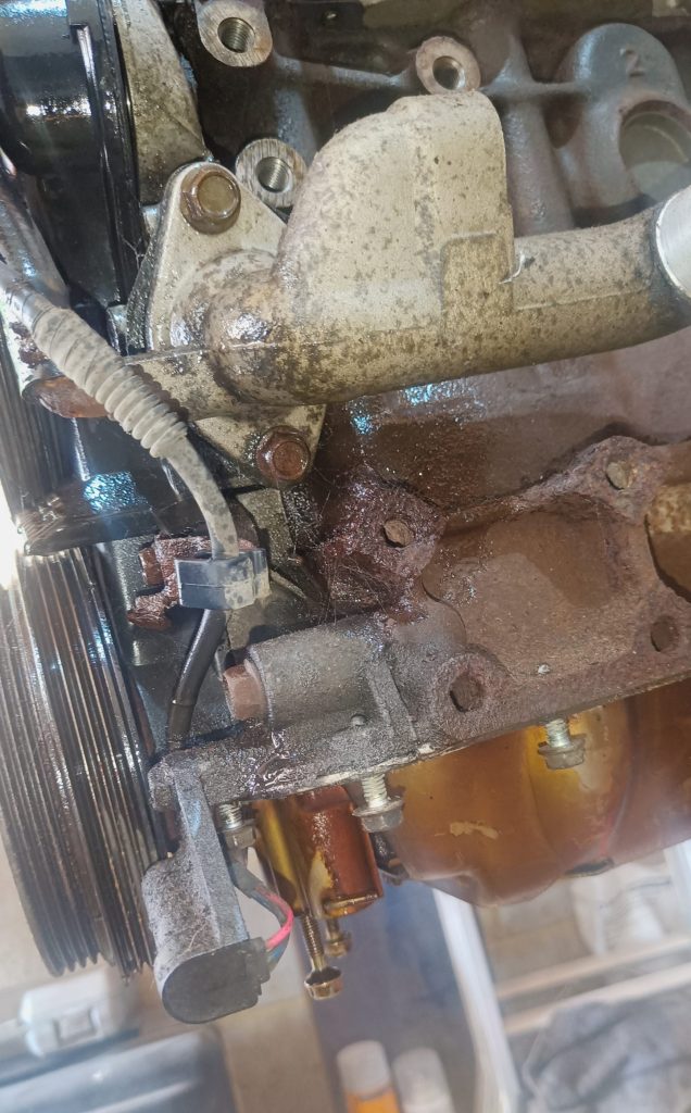 Image of LHS front of engine showing crank position sensor location.