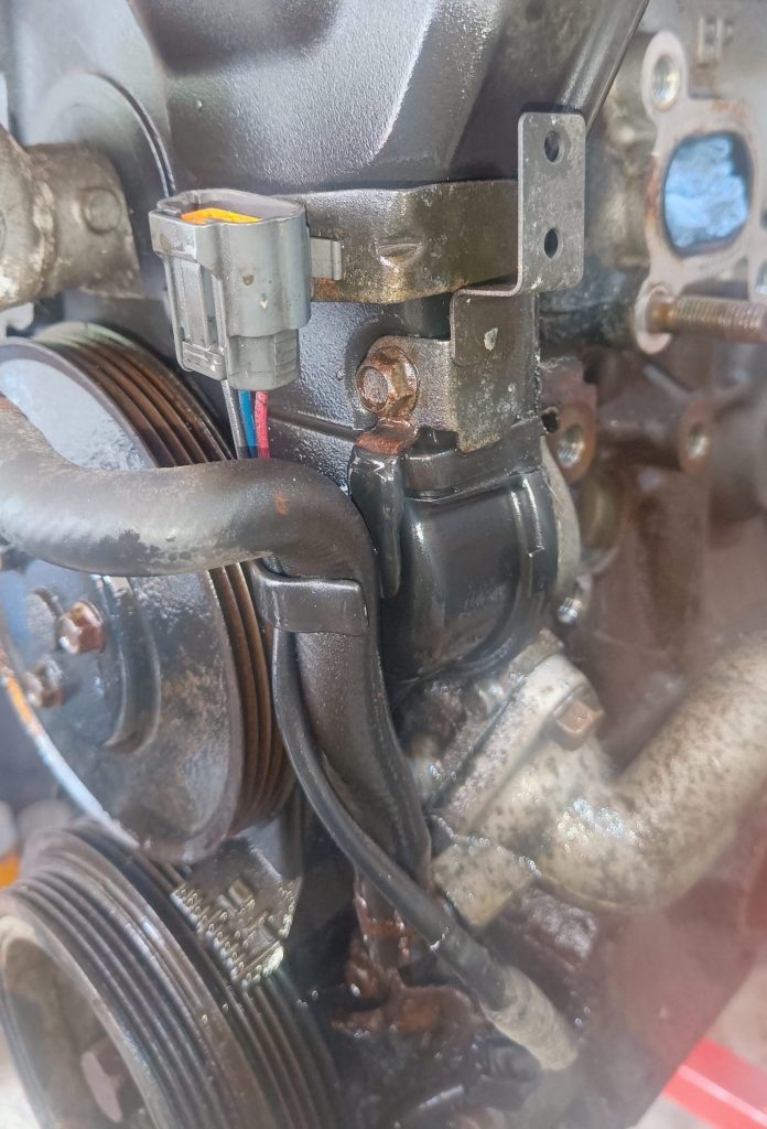 Image of LHS front of engine showing crank position sensor connector location.