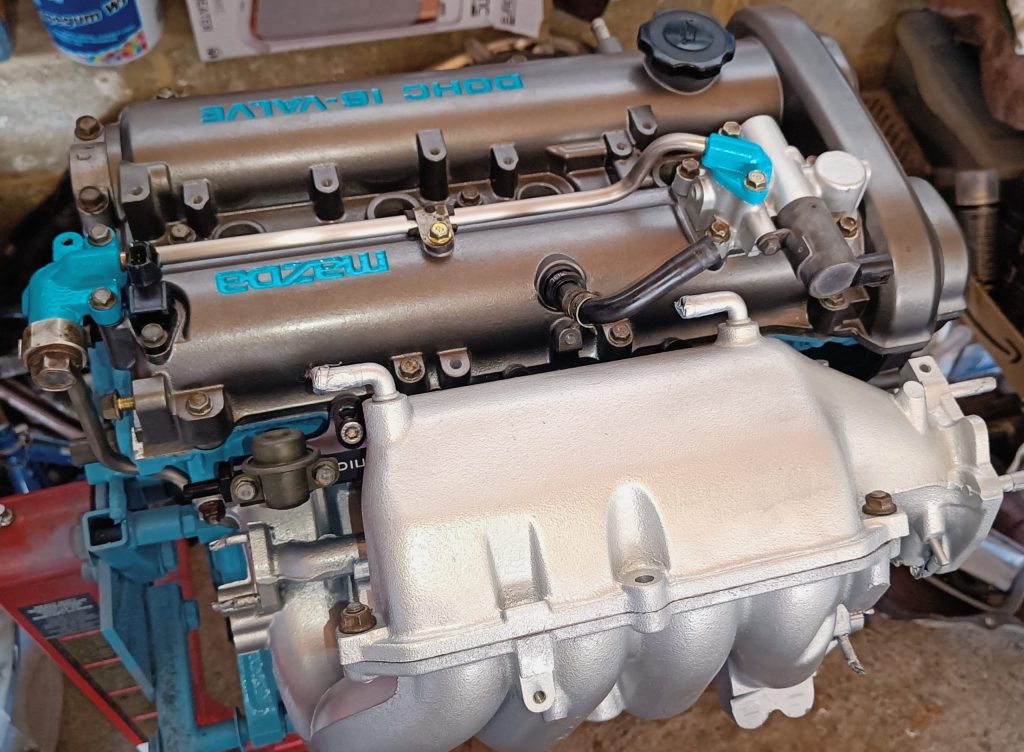 Image of engine with refurbished and painted parts reinstalled.