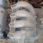 Image of VHT primed inlet manifold and VVT parts.