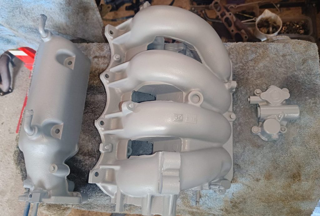 Image of VHT primed inlet manifold and VVT parts.