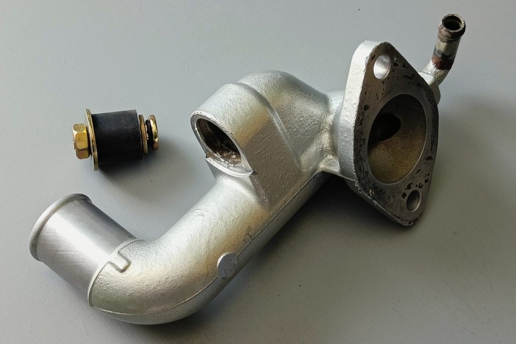 Image of coolant mixer manifold and heater delete bung solution.