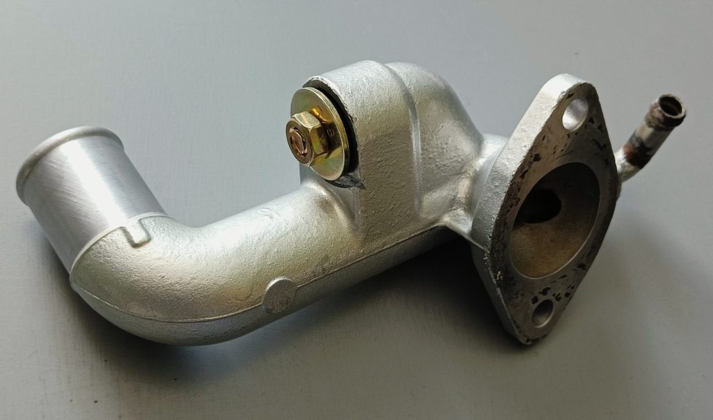 Image of coolant mixer manifold and heater delete bung solution.