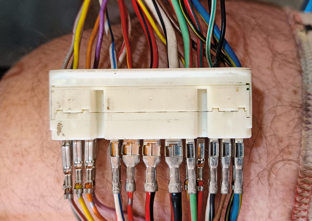 Image of cable retention side of X-10 engine fuse box connector.